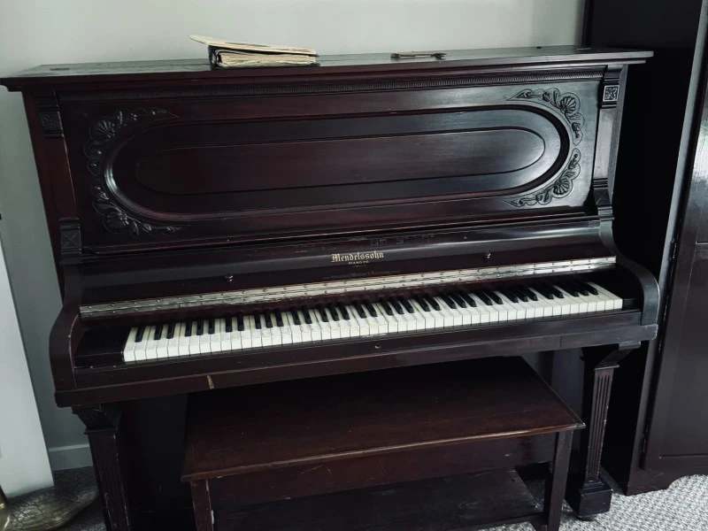 Mendesson upright 54" high, 27" deep, 57" wide piano